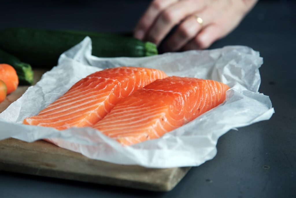 raw fish meat on brown chopping board