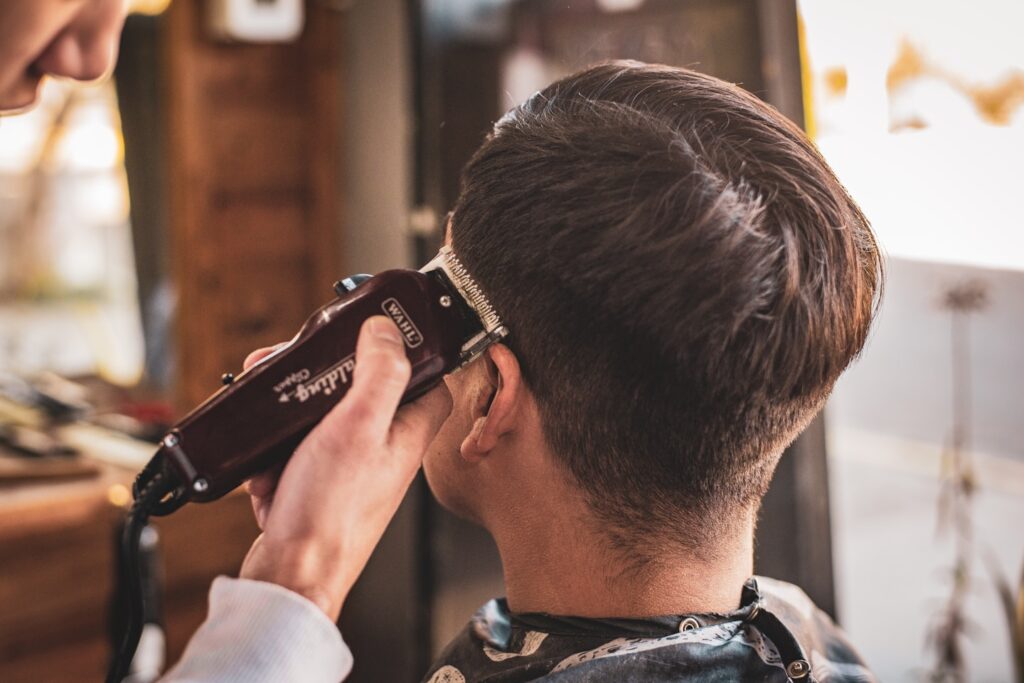 man in white dress shirt holding black dslr camera