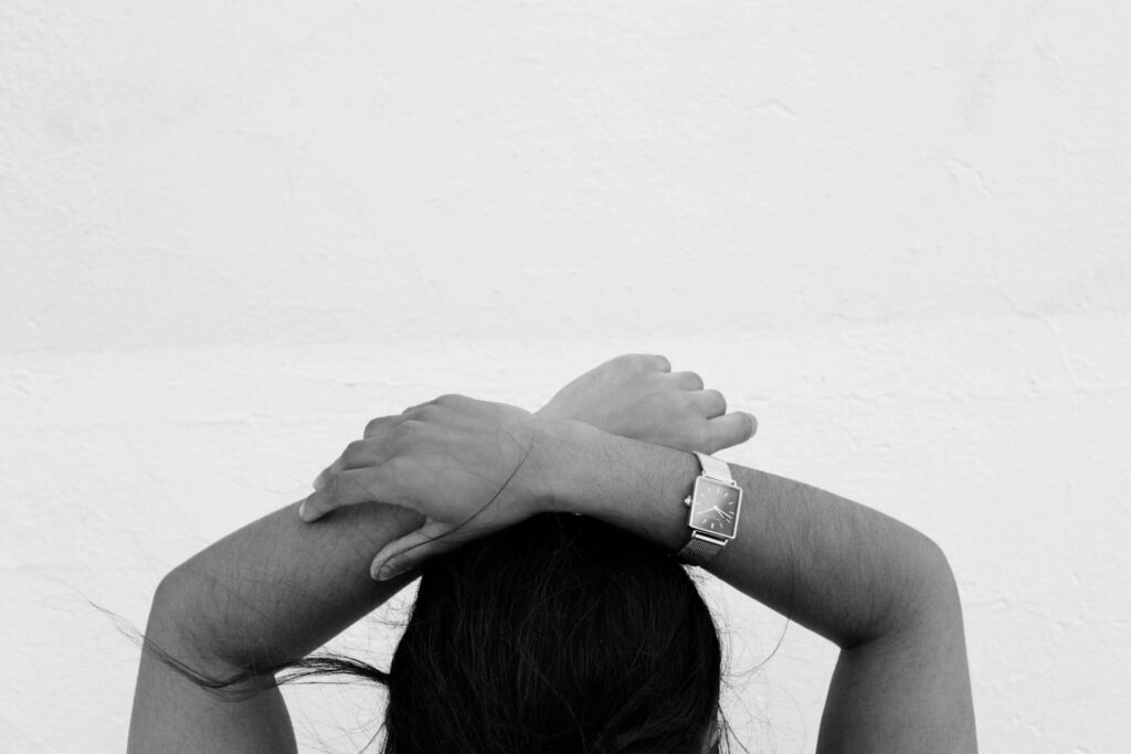 grayscale photography of person holding hands